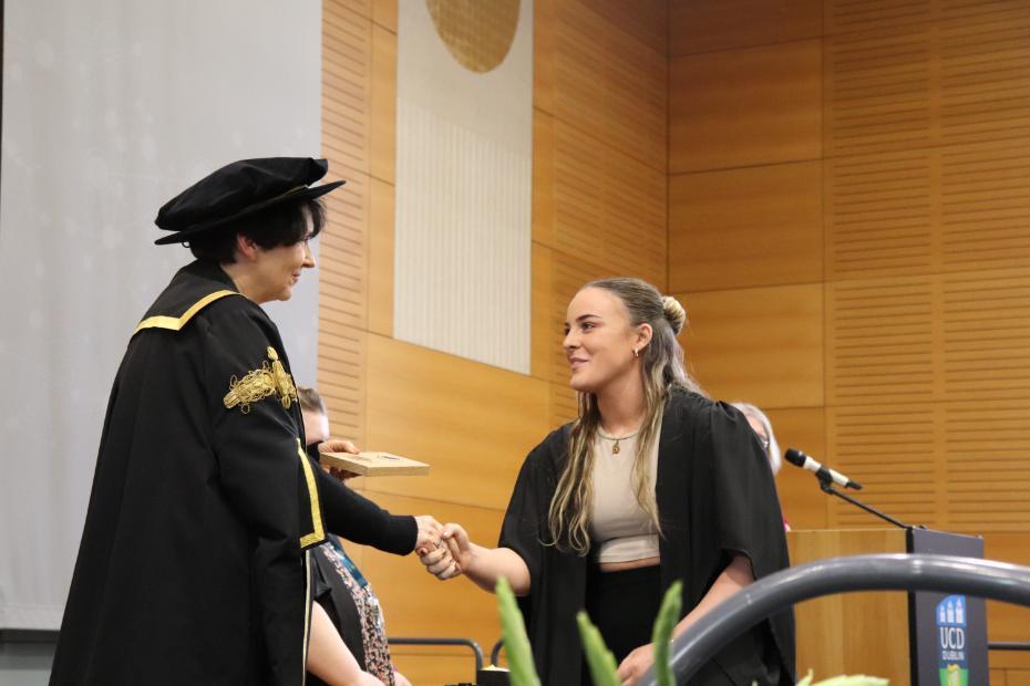 Emma Kelly receiving her award from UCD President Professor Orla Feely